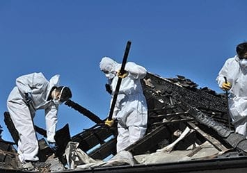 workers cleaning up fire damage